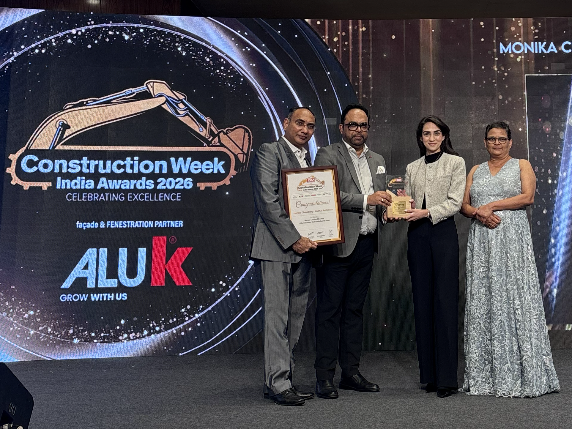 Monika Choudhary and fellow attendees holding the Woman Leader of the Year award at the Construction Week India Awards 2026.