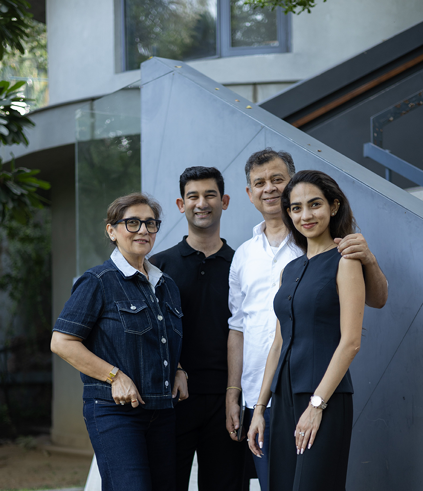 Four members of ZHCollective | Habitat Architects posing together in a contemporary building